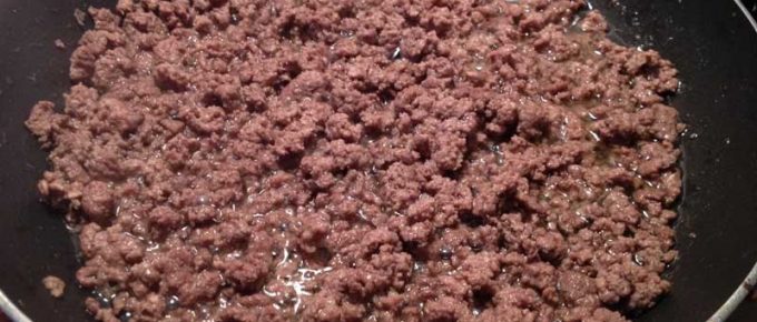 Ground beef cooking in skillet