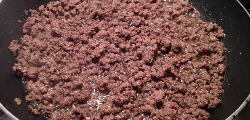 Ground beef cooking in skillet