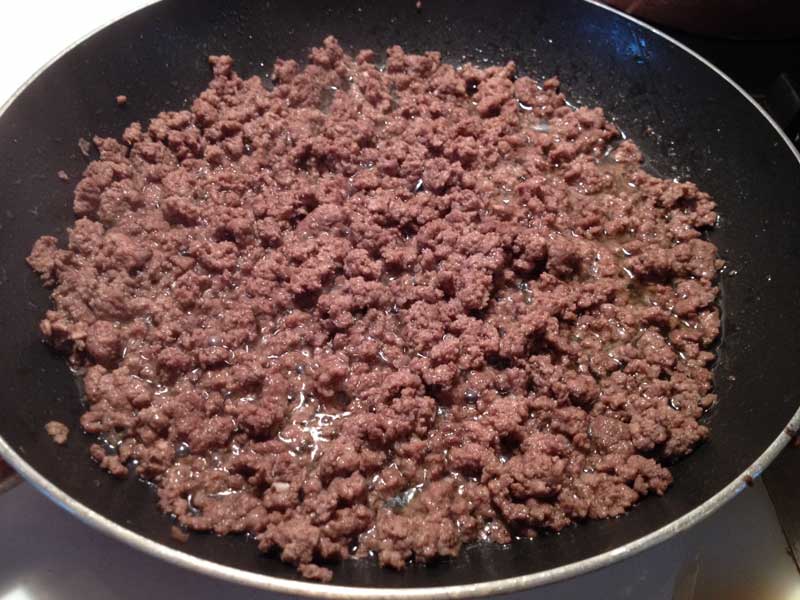 Ground beef cooking in skillet